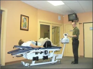 This is our Trition DTS Spinal Decompression table (no you are not actually getting treated in the main hallway).