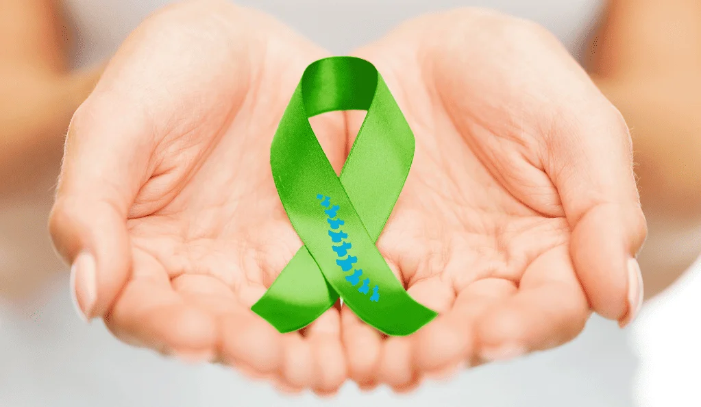 Scoliosis Awareness Month - Understanding the Significance - for patients 1 awareness green ribbon hand
