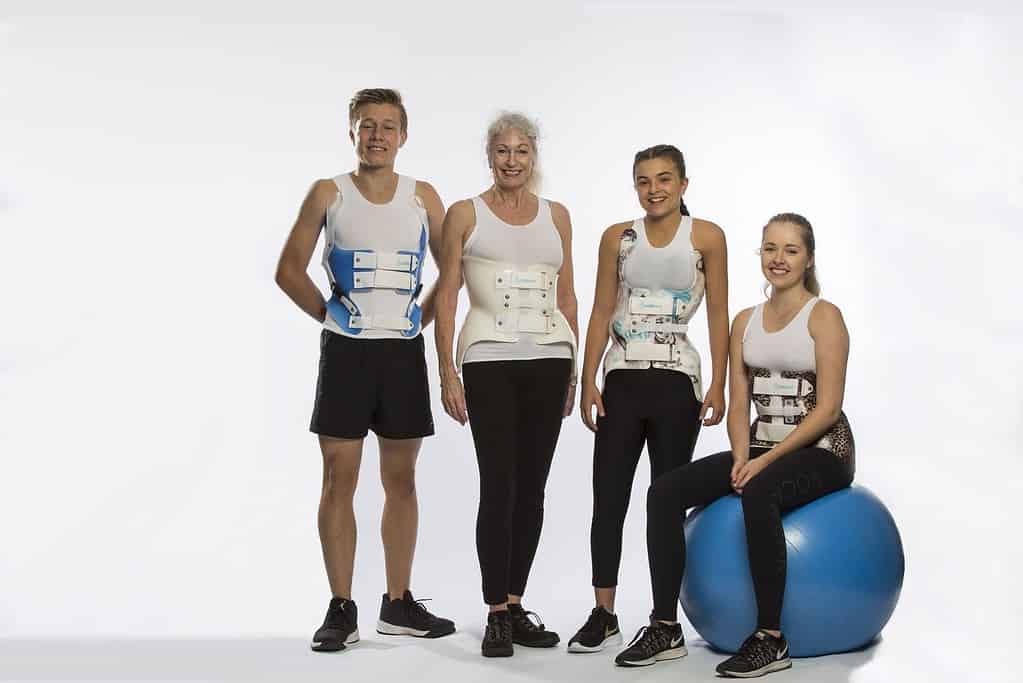 Why Refer To Scoliosis Center of LA 3 Back brace for scoliosis; diverse patients at chiropractic rehab center; spinal correction treatment; scoliosis management with custom braces.